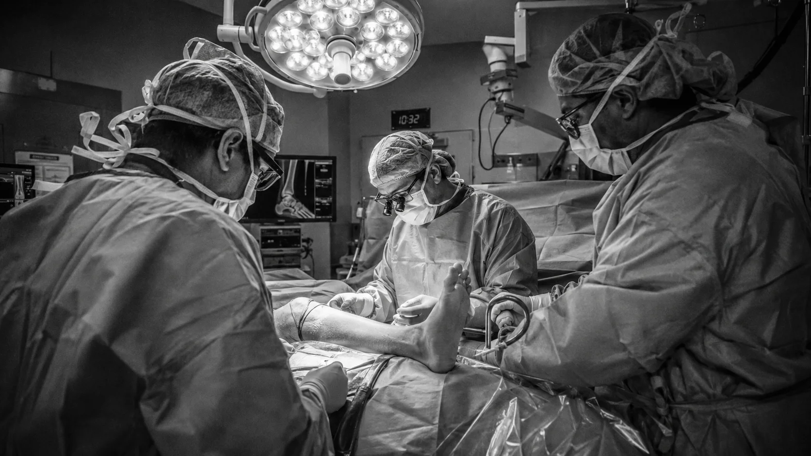 Foot and ankle surgical team performing a procedure in an operating room