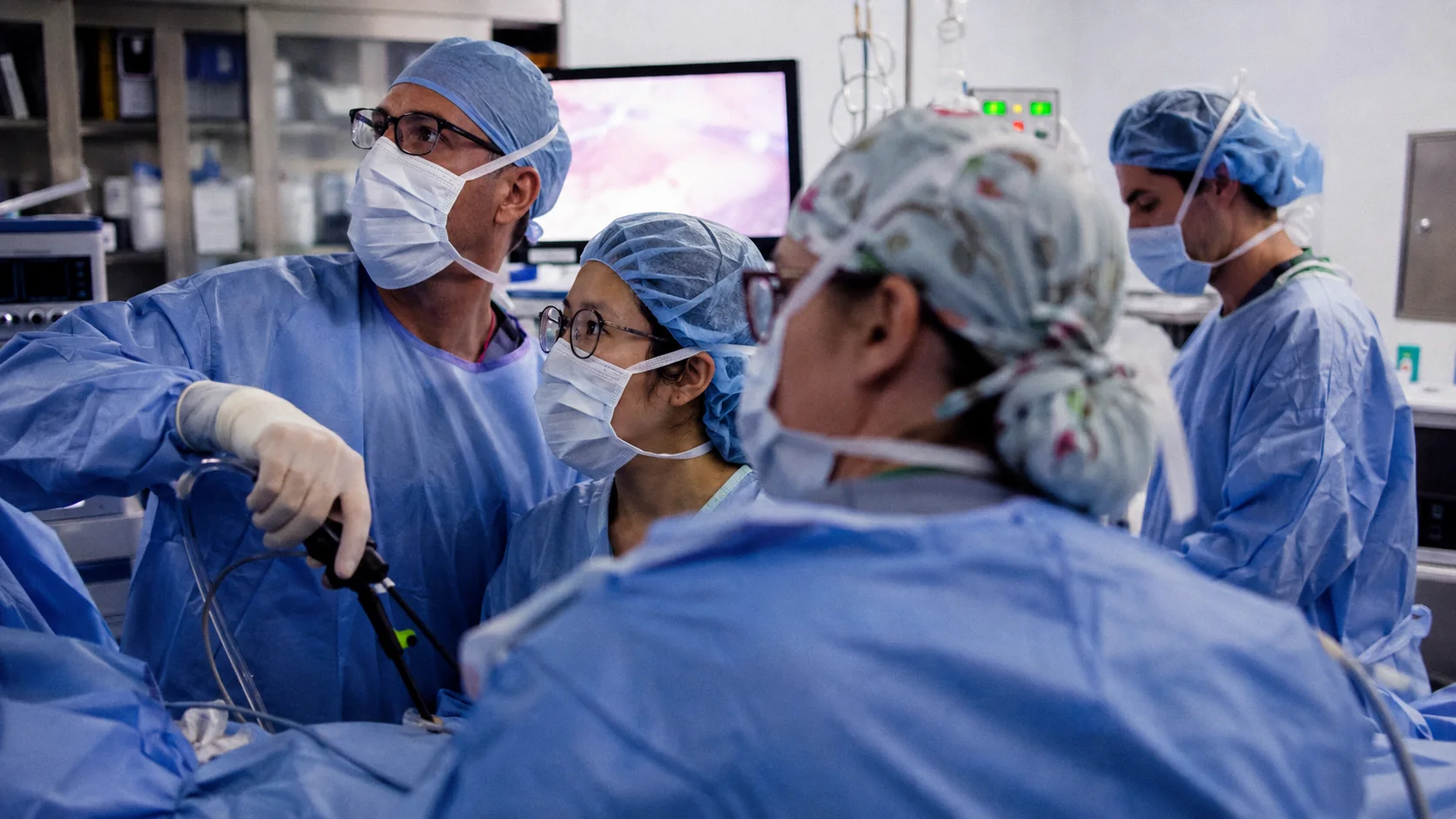 Thoracic surgical team performing a minimally invasive procedure in an operating room